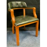 A 20th century Beechwood captain's chair, green leather padded seat, arms, and back.