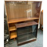 An Avalon teak bookcase, twin sliding doors, tapering block legs, 75cm high, 104cm wide, 30cm