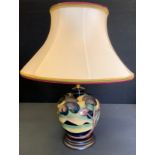 A Moorcroft Western Isles pattern compressed ovoid table lamp, designed by Sian Leaper, wooden base,