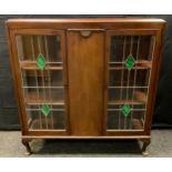 A mid 20th century mahogany display cabinet, the pair of glazed, leaded doors with malachite glass