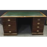 An early to mid 20th century pedestal desk, four short drawers to one pedestal, two short and a