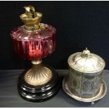 An EPBM biscuit barrel and cover, c.1880; a Victorian cranberry and gilt metal oil lamp, c.1870 (2)