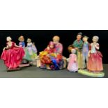 A Royal Doulton figure, Pantettes, HN1362; The Orange Lady, HN1953; Delight, HN1772; Spring Flowers,