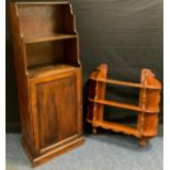 A mid 20th century oak waterfall bookcase cupboard, 139cm tall x 50cm wide x 34cm depth, c.1950; a