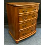 A mid 20th century mahogany bedside chest, rounded rectangular top, four graduated short drawers,