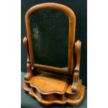 A Victorian mahogany toilet mirror, arched top, serpentine front, 55cm high, 42cm wide, 21cm deep