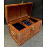 A 20th century teak, domed-top trunk, brass inlay with foliate scrolls, the interior with lift-out