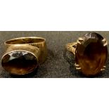 A 9ct gold ring set with a single faceted smokey quartz, size N, 5.4g; another 9ct gold smokey