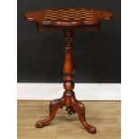 A Victorian walnut and mahogany tripod games table, of small and neat proportions, shaped top with