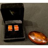 A pair of amber and silver Art Deco cufflinks; an amber scorpion tablet