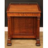 An Arts & Crafts period oak Davenport desk, hinged sloping top with inset tooled writing surface