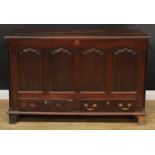 A George III oak mule chest, hinged cover enclosing three small drawers, the front with four