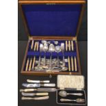 A silver two piece christening set; EPNS flatware in an oak case