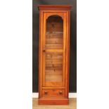 A Victorian mahogany and pine cabinet, moulded cornice above a glazed door and a drawer, plinth