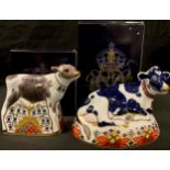 A Royal Crown Derby paperweight, Friesian Cow Buttercup, gold stopper, boxed; another Bluebell Calf,