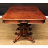 A 19th century mahogany triple pillar dining table, rounded rectangular top, the central leaf