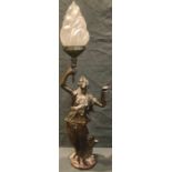 A bronzed spelter table lamp modelled as a classical maiden holding torch aloft, frosted glass