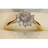 An 18ct gold diamond cluster ring, the central brilliant cut stone approx. 0.38cts, surrounded by