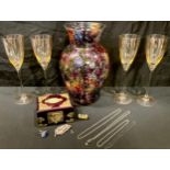 A set of four champagne glasses; a large colourful baluster glass vase, painted with flowers; a