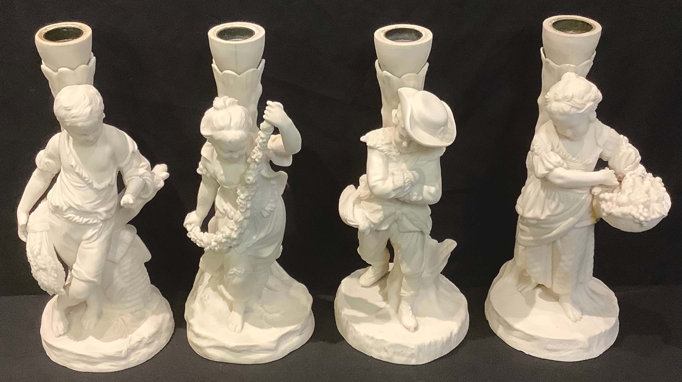 A set of four Victorian Copeland Parian figural candlesticks, The Four Seasons (lacking branches)