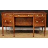 A George III mahogany bow front sideboard, slightly oversailing top above three frieze drawers,