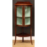 An Edwardian floor-standing bow front corner display cabinet, the doors outlined with barberpole