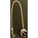 A Victorian agate egg shaped locket on chain