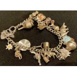 A silver charm bracelet, Birmingham 1961, with nineteen charms