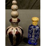 A blue flashed faceted cut glass scent bottle, drop-in stopper, floral embossed gilt hinged cover,