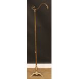 A brass swan neck floor lamp, triform base, stylised paw feet, 169.5cm high