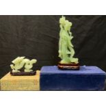 A Chinese jade carving of a dragon, 12cm long, hardwood base, boxed; another, as a courtesan (2)