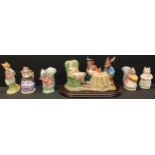 A Beswick figure group, The Mad Hatters Tea Party, by Royal Doulton, wooden stand; Royal Albert