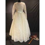 A 1950's lace wedding dress; two Victorian silk parasols