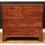 A George III mahogany chest, of two short over three long graduated drawers, skirted base, bracket