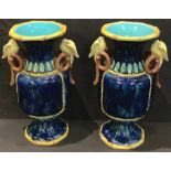 A pair of Aesthetic Movement majolica two handled urnular vases, 34cm high, c.1880