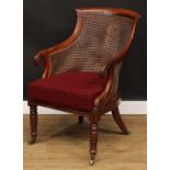 A George/William IV mahogany bergère library chair, in the manner of Gillows of Lancaster and