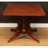 A Regency mahogany breakfast table, rounded rectangular tilting top, turned column, sabre legs,