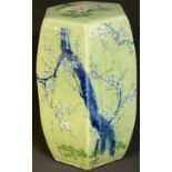 A Chinese celadon glaze hexagonal garden seat, painted in low relief with blossoming prunus, pair of