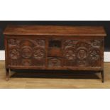 A 17th century and later oak six-plank chest, hinged rectangular top with notched ends above a panel