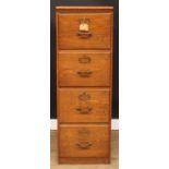 An oak four-drawer filing cabinet, 132cm high, 45cm wide, 68cm deep