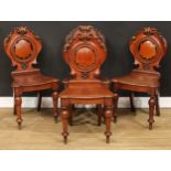 A set of four Victorian oak hall chairs, 89cm high, 47cm wide, the seat 36cm deep (4)