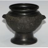 A Chinese bronze jar, cast and applied with ferocious dragons and temple lion masks on a ground of