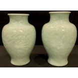A pair of Chinese celadon vases, 21cm high