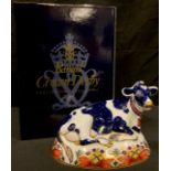 A Royal Crown Derby paperweight, Friesian Cow Buttercup, gold stopper, boxed