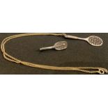 An 800 silver and neillo tennis racquet and ball brooch; a silver tennis racquet pendant