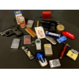 A collection of cigarette lighters including novelty, advertising, etc; two cigarette cases as