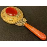 An ornate Chinese hand mirror, gilt set oval agate to verso, agate handle, 16.5cm long