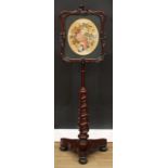 A Victorian mahogany pole screen, shaped rectangular banner frame carved with acanthus, flowers