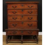 An 18th century oak chest on stand, rectangular top above four long drawers, the projecting base