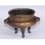 A Chinese bronze tripod censer, cast temple lion mask handles, tall serpentine legs, 16cm wide, 19th